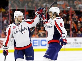 Washington Capitals defenceman Mike Green, left, congratulates Alex Ovechkin after his teammate scored a goal during an NHL game against the Philadelphia Flyers in January 2015.