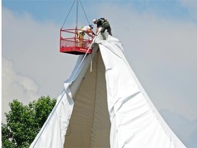 Workers install the new canopy on the Amphitheatre in Hawrelak Park in Edmonton on June 23, 2014. Crew members of the Freewill Shakespeare Festival discovered a leak in the canopy last week.