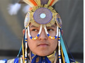 16 year old Breyson Deschamps, in grass dance regalia, waits to go onstage at Aboriginal Day Live in Louise McKinney Park on Saturday, June 20, 2015.