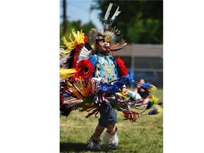 11-year-old Broxy Morin of the Thundering Spirit Cultural Society was happy after a fancy dance at the Bent Arrow Traditional Healing Society’s round dance and powwow in celebration ahead of National Aboriginal Day at Parkdale school in Edmonton on Friday June 19, 2015.