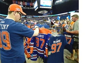 Zach Ziobron might want to update his T-shirt with the first round Oilers draft choice Connor MacDavid at the annual Oilers Locker Room Sale, collectibles, new & used equipment and more on sale at Rexall Place in Edmonton, June 27, 2015.