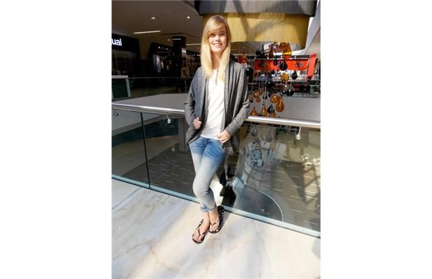 Courtney Nickerson wears skinny jeans from Monjeloco Jeans, white top with leather trim from Dynamite, and a grey sweater with lace inset from Bootlegger.