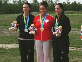 Amanda Chudoba of Spruce Grove stands on the podium with runners-up Kayle Browning and Kimberley Bowers, both from the United States, after the women’s trap shooting final at the Pan Am Games on Monday.
