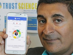 Ashif Mawji of Trust Science displays his company’s smartphone app. The app will assign “trust scores” to individuals and organizations by extracting data from a variety of sources.