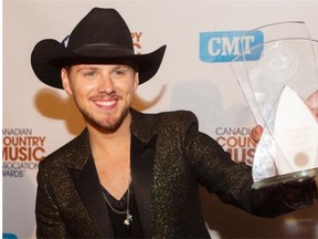 Brett Kissel holds the award for CMT Video of the Year at Rexall Place during the CCMA Awards on Sept 7, 2014.