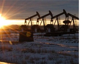 In this Jan. 14, 2015 file photo, some of the 60 rigs that are drilling surrounding McKenzie County, 40 percent of the rigs statewide, work in western North Dakota.