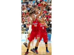 Canada’s Kim Gaucher reaches toward the basket with the ball while Puerto Rico’s Tayra Melendez, left, and Jennifer O’Neil attempt to defend during a FIBA Americas Women’s Championship basketball game at the Saville Community Sports Centre on Sunday, Aug. 9, 2015.