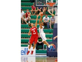 Canada’s Miah-Marie Langlois and Dominican Republic’s Genesis Evangelista battle over a rebound during a FIBA Americas Women’s Championship game at the Saville Community Sports Centre on Aug. 11, 2015.