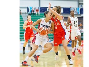 Canada’s Kia Nurse (5) drives into  Chile’s Barbara Cousino (10) during Day 2 of the FIBA Americas Women’s Basketball tournament at Saville Centre in Edmonton on August 10, 2015.