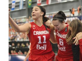 Canada’s Shona Thorburn is helped off the court by teammate Natalie Achonwa (11) after being injured early in Thursday’s Americas Women’s Basketball Championship game against Cuba at the Saville Community Sports Centre.