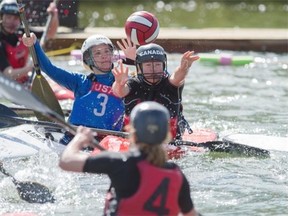 Canada’s Sierra Foged makes a pass while being pressured by Katherine Homann of the United States during a round-robin game in the Pan American canoe polo championships at  Rundle Park on Saturday.