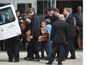 The casket is brought out after the memorial service Friday for Jade MacDonald, the two-year-old girl who died Saturday in a stormwater lake in the Morinville subdivision where she lived.