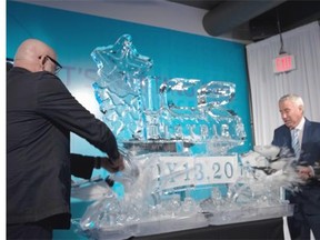 City councillor Scott McKeen, left, Oilers Entertainment Group CEO Bob Nicholson, centre, and Katz Group Senior VP Glen Scott take hammers to an ice sculpture to announce the renaming of the Edmonton Arena District as Ice District, in Edmonton on July 13, 2015.