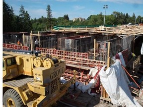 Crews are now working 17 hours a day, seven days a week to complete the 102nd Avenue Bridge, after construction was delayed when girders buckled.