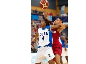 Cuba’s Francy Ochoa Izquierdo (4) battles for the ball with Canada’s Kia Nurse (5) at the FIBA Americas Women’s Basketball tournament in Edmonton last Sunday. Canada defeated Cuba 82-66 for the gold.