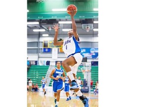 Cuba’s Fransy Ochoa (4) does a layup against Dominican Republic during Day 2 of the FIBA Americas Women’s Basketball tournament at Saville Centre in Edmonton on August 10, 2015.