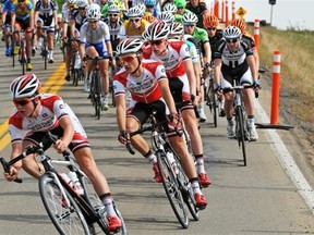 Cyclists head down a steep hill entering a sharp corner during a rural stage of the Tour of Alberta race on Sept. 5, 2014.