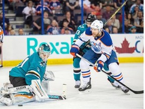 Derek Roy (8) tries to get to a loose puck for the Oilers despite the efforts of San Jose Sharks’ Matt Nieto (83) and goalie Antti Niemi (31) during a game in Edmonton last season. Roy is waiting for an offer from an NHL team, like many unrestricted free agents this summer.