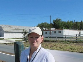 Diane David, Executive Director, Whitemud Equine Learning Centre Association, in front of the existing indoor arena, office trailers and barn which will be demolished after the new building is completed.