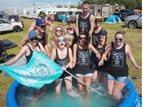 The ‘drinking class’ campsite splash around in their pool as temperature rose on Sunday at Big Valley Jamboree country music festival in Camrose on August 2, 2015.