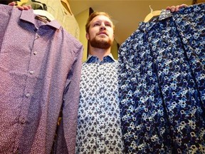 Connor Pregizer of Moltisenti Clothing at Southgate shows some of his shop's floral patterned dress shirts.