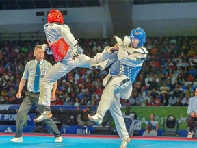 Edmonton’s Eric Wah, a top international taekwondo referee, officiates at a competition in Mexico. Wah travels to more than 30 championships every year.