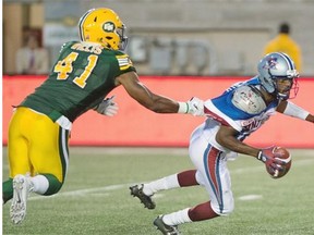 Edmonton Eskimos defensive end Odel Willis grabs the jersey of Montreal Alouettes rookie quarterback Rakeem Cato during Thursday’s Canadian Football League game at Percival Molson Memorial Stadium in Montreal.
