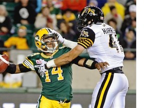 Edmonton Eskimos quarterback James Franklin is tackled by Hamilton Tiger Cats Erik Harris during Friday’s CFL game.