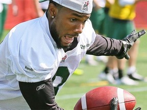 Edmonton Eskimos wide receiver/kick-returner Wallace Miles pretends he’s about to get hit by a defensive player during Friday’s walk-through practice at Clarke Field.