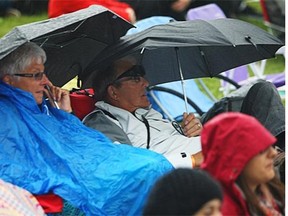 Edmonton Folk festival attendees took cover from the rain in 2014.