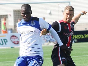 FC Edmonton midfielder Lance Laing and Ottawa Fury FC defender Ryan Richter fight for possession of the ball during North American Soccer League action at Fort McMurray on Aug. 2, 2015.