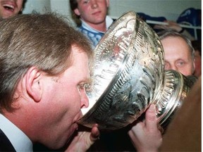 Edmonton Oilers coach and general manager Glen Sather takes a sip from the Stanley Cup after his team defeated the New York Islanders to win its first NHL championship in 1984.