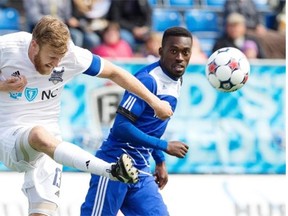 FC Edmonton’s Tomi Ameobi and Carolina RailHawks’ Connor Tobin battle for the ball during Sunday’s North American Soccer League game at Clarke Field.