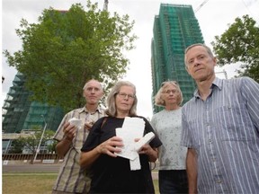 From left, Riverdale residents Eric Gormley, Rocky Feroe, Judith Golub and John Walker hold some of the garbage they say flies off the Edgewater towers and drifts into the river valley in Edmonton.
