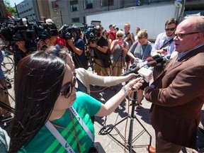 Interim TransLink CEO Doug Allen, right, comments on the results of a Metro Vancouver transit plebiscite during a news conference on July 2, 2015. Residents of Metro Vancouver rejected a half-per-cent sales tax with 62 per cent of those returning ballots voting no to the increase that was to fund $7.5 billion in transportation upgrades. TransLink is the region’s transit authority.