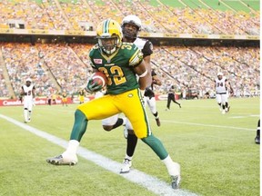Kendial Lawrence carries the ball into the end zone to score a touchdown for the Edmonton Eskimos during a Canadian Football League game against the Ottawa Redblacks at Commonwealth Stadium on July 9, 2015.