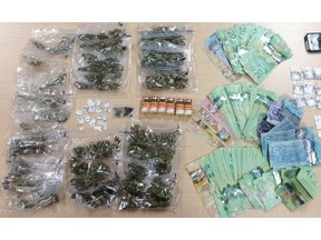 A large quantity of drugs and cash seized Friday by the RCMP at the entrance to the Grimshaw Rodeo.