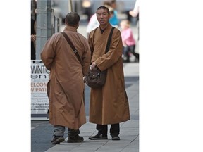 At least five men dressed as monks approached people on Jasper Avenue asking for money donations in Edmonton on Tuesday Aug. 18, 2105. It is not an accepted form of Buddhism, an Edmonton Buddhist says.