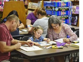 Lily Holmes, 3-1/2, is the youngest person in the room Tuesday as she attends a colouring party hosted by Audrey Books with her parents John and Vicki.