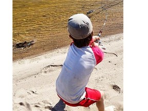 Mali, the five-year-old son of Benoit Gendreau-Berthiaume and Magali Moffatt, reels in a northern pike on the Saskatchewan River. Mali seems to like the fishing most of all on the family’s months-long paddling adventure, says his father.