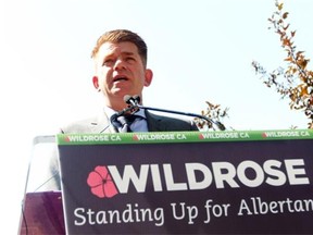 How many “excess” communications staffers and mid-level bureaucrats does the Alberta government employ, according to Brian Jean? The Wildrose leader is shown on the campaign trail in Calgary-Foothills on Aug. 13, 2015.