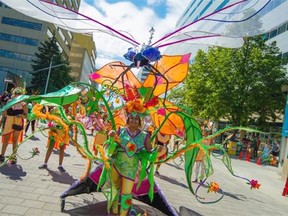 Marina Tayloo takes part in the Cariwest parade on Saturday, Aug. 8, 2015, as it makes its way through downtown Edmonton. The parade is part of the three-day Caribbean arts festival hosted primarily in Edmonton’s downtown Churchill Square — renamed Caribbean Village for the weekend — that also includes celebrations of food, music, dance and costume.