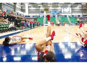 Members of Team Canada stretch before playing Chile during Day 2 of the FIBA Americas Women’s Basketball tournament at Saville Centre in Edmonton on August 10, 2015.