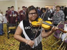 Metis fiddler Brianna Lizotte led the procession for a memorandum of understanding to formalize a commitment between the Metis Nation, Fort Edmonton and the mayor to work together to present Metis stories with historical accuracy at Fort Edmonton Park, in Edmonton on Friday August 7, 2105.