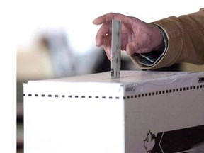 A man casts his vote for the 2011 federal election.