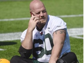 Offensive lineman Justin Sorenson chats on his cellphone after the Edmonton Eskimos’ practice at Commonwealth Stadium on Tuesday.