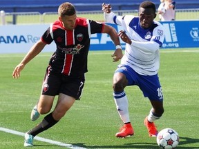 Ottawa Fury FC forward Carl Haworth and FC Edmonton forward Tomi Ameobi fight for positioning during NASL action in Fort McMurray Alta. on Sunday August 2, 2015. Robert Murray/Fort McMurray Today/Postmedia Network