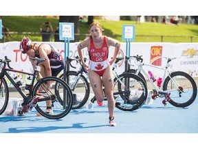 Canada's Paula Findlay transitions from cycling to running during the Women's Triathlon at the Pan Am Games in Toronto on July 11, 2015.