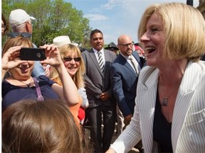 Premier Rachel Notley greets the crowd after she and 11 cabinet ministers are sworn in on the legislature steps in Edmonton on May 24, 2015.