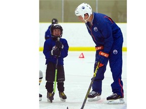 Ryan Nugent-Hopkins helps out at the Edmonton Oilers hockey school for youth at the Leduc Recreation Centre on Aug. 13, 2015.
